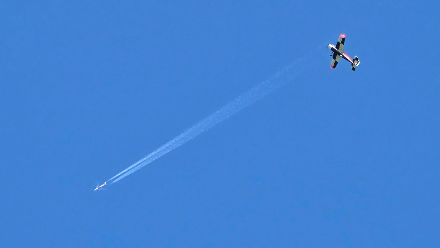 Model airplane and a big airliner passing by.